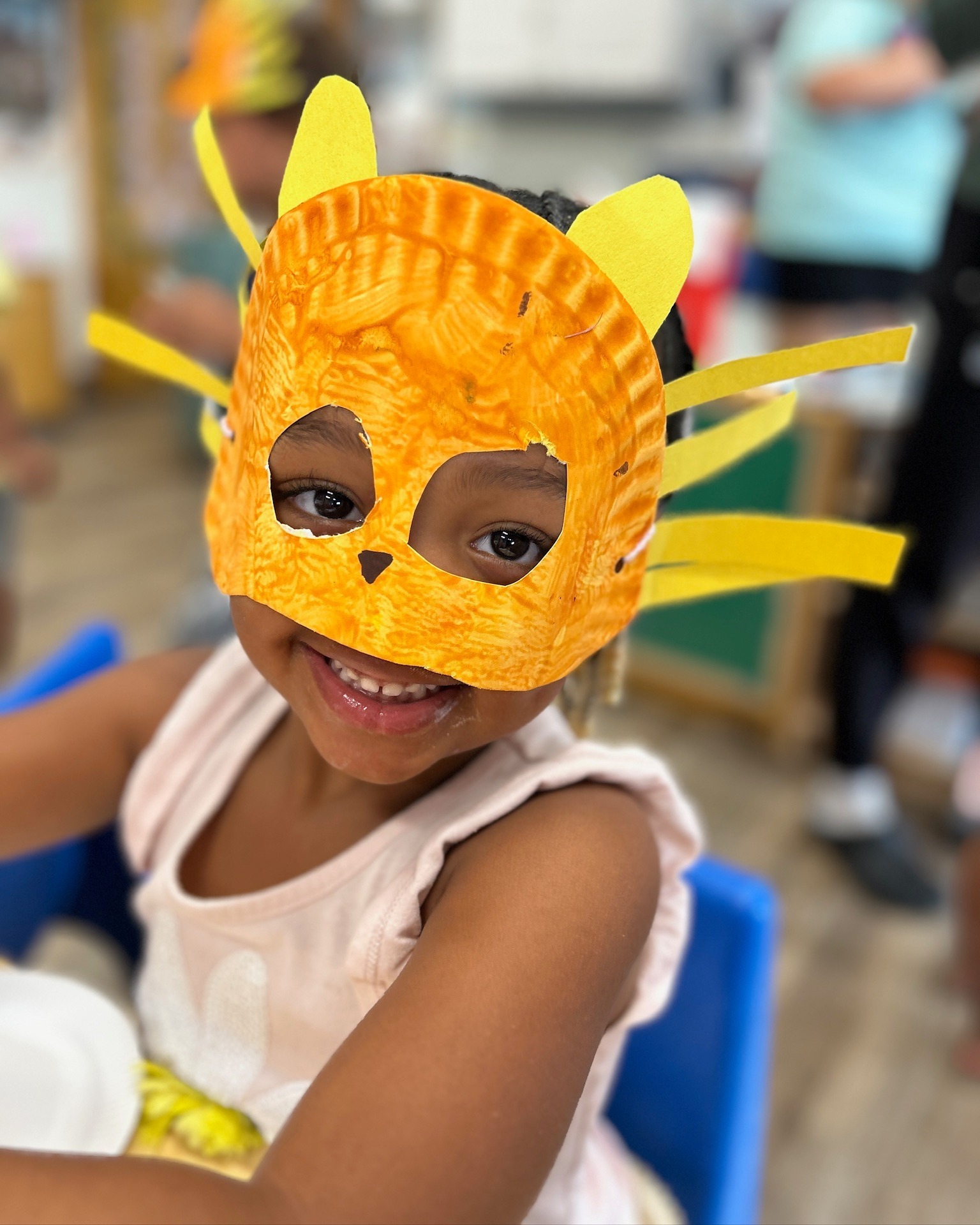 Child wearing a handmade cat mask
